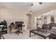 Open-concept living room with a desk, hardwood floors, and lots of natural light at 2748 E Dennisport Ave, Gilbert, AZ 85295