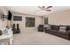 Cozy living room with plush carpeting, comfortable seating, and soft, natural light at 2748 E Dennisport Ave, Gilbert, AZ 85295