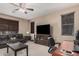Cozy living room featuring natural light, a ceiling fan, and a comfortable couch at 2748 E Dennisport Ave, Gilbert, AZ 85295