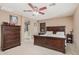 Spacious main bedroom suite featuring a large bed, ceiling fan, and an en-suite bathroom at 2748 E Dennisport Ave, Gilbert, AZ 85295