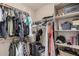 Organized walk-in closet with ample shelving, rods, and storage for clothing and accessories at 2748 E Dennisport Ave, Gilbert, AZ 85295