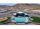 Aerial view of the community pool, clubhouse, playground, and surrounding desert landscape at 32487 N 122Nd Ave, Peoria, AZ 85383