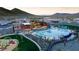 Resort-style community pool with lounge chairs, umbrellas, and a modern clubhouse at 32487 N 122Nd Ave, Peoria, AZ 85383