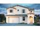 Charming two-story home with a stucco facade, tiled roof, and attached two-car garage at 32487 N 122Nd Ave, Peoria, AZ 85383