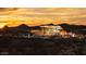 Dusk view showcasing the community clubhouse and pool, creating a serene ambiance with mountain backdrop at 32487 N 122Nd Ave, Peoria, AZ 85383