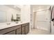 Bright bathroom featuring double vanity with modern fixtures and a walk-in shower at 32693 N Jasper St, San Tan Valley, AZ 85143