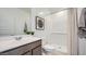 Bright bathroom with a modern vanity, ample lighting, and a pristine shower, offering a refreshing and functional space at 32693 N Jasper St, San Tan Valley, AZ 85143
