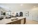 Modern kitchen island boasts sleek countertops, stainless steel appliances, and ample storage, ideal for cooking and gathering at 32693 N Jasper St, San Tan Valley, AZ 85143