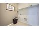Functional laundry room offers a convenient space for laundry tasks, complete with ample shelving for storage solutions at 32693 N Jasper St, San Tan Valley, AZ 85143