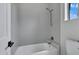 Contemporary bathroom featuring a bathtub with a shower and neutral-toned tiling at 3624 N Paseo Del Sol --, Mesa, AZ 85207