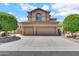 Front exterior view of a two-story home featuring a three-car garage and arched window at 3624 N Paseo Del Sol --, Mesa, AZ 85207