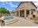 Backyard pool and patio with a covered seating area and a unique outdoor fireplace, ideal for relaxation and entertaining at 3624 N Paseo Del Sol --, Mesa, AZ 85207