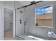 Sleek shower with glass enclosure, modern fixtures, and a window providing natural light and a view at 3624 N Paseo Del Sol --, Mesa, AZ 85207
