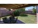 Cozy covered patio offers serene views of the expansive backyard and verdant landscaping at 3633 W Redfield Rd, Phoenix, AZ 85053