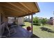 Covered patio overlooking a well-maintained backyard with lush greenery and mature trees at 3633 W Redfield Rd, Phoenix, AZ 85053