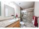 Modern bathroom with granite countertop, sink, wood cabinets, and tiled glass shower with brushed metal fixtures at 3633 W Redfield Rd, Phoenix, AZ 85053