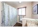 Clean bathroom featuring a wood-look floor, granite countertop, a shower curtain, and window at 3633 W Redfield Rd, Phoenix, AZ 85053