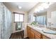 Well-lit bathroom featuring a wood-look floor, granite countertop, and shower curtain at 3633 W Redfield Rd, Phoenix, AZ 85053