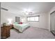 Serene bedroom showcasing carpet flooring, soft lighting, a large window, and a ceiling fan for added comfort at 3633 W Redfield Rd, Phoenix, AZ 85053