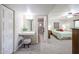 Primary bedroom with a vanity, a view of the shower and a spacious area with carpet flooring and a ceiling fan at 3633 W Redfield Rd, Phoenix, AZ 85053