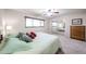 Bright bedroom featuring neutral walls, plush carpet, and mirrored closet reflecting the bed at 3633 W Redfield Rd, Phoenix, AZ 85053