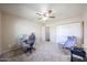 Bedroom showcasing neutral carpet, a ceiling fan, an office chair, and a printer at 3633 W Redfield Rd, Phoenix, AZ 85053