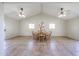 Bright dining room featuring a vaulted ceiling, dual ceiling fans, and a round wooden table with seating for six at 3633 W Redfield Rd, Phoenix, AZ 85053