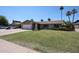 Inviting single-story home with a lush front yard and a welcoming exterior appeal at 3633 W Redfield Rd, Phoenix, AZ 85053