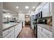 Bright kitchen featuring stainless steel appliances, granite countertops, and white cabinets at 3633 W Redfield Rd, Phoenix, AZ 85053