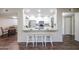 Bright kitchen featuring a breakfast bar, white cabinets, and stainless steel appliances at 3633 W Redfield Rd, Phoenix, AZ 85053