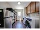 Laundry room with stainless steel refrigerator, shelving, and white washer and dryer at 3633 W Redfield Rd, Phoenix, AZ 85053