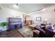 Comfortable living room with a piano, a leather couch, and an open layout at 3633 W Redfield Rd, Phoenix, AZ 85053