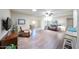 Cozy living room showcasing wood floors, a comfortable leather sofa, and an open layout leading to the dining area at 3633 W Redfield Rd, Phoenix, AZ 85053