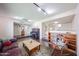 Cozy living room with a piano, hardwood floors, and built-in bookshelves providing a warm, inviting atmosphere at 3633 W Redfield Rd, Phoenix, AZ 85053