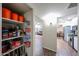 Pantry with stocked shelves adjacent to living spaces and modern kitchen at 3633 W Redfield Rd, Phoenix, AZ 85053