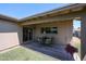 Covered patio with a dining set and view of the green, landscaped backyard at 3633 W Redfield Rd, Phoenix, AZ 85053