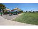 Community playground with shade canopies on large green lawn area at 3633 W Redfield Rd, Phoenix, AZ 85053
