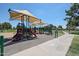Community playground featuring shade structures and modern play equipment for children of all ages at 3633 W Redfield Rd, Phoenix, AZ 85053