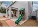 Backyard patio with playground, covered patio with outdoor furniture and grill at 41678 N Salix Dr, San Tan Valley, AZ 85140