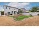Wide backyard with a covered patio, swing set, privacy wall and grass area at 41678 N Salix Dr, San Tan Valley, AZ 85140
