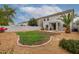 Large backyard featuring a covered patio, swing set, and a large grass area at 41678 N Salix Dr, San Tan Valley, AZ 85140