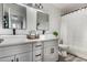 Bright bathroom featuring a double sink vanity with modern fixtures and gray cabinets at 41678 N Salix Dr, San Tan Valley, AZ 85140