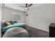 Cozy bedroom featuring neutral walls, carpet, a bean bag chair, and a fan at 41678 N Salix Dr, San Tan Valley, AZ 85140