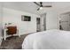 Bright bedroom with ceiling fan, television, and desk, offering comfort and functionality at 41678 N Salix Dr, San Tan Valley, AZ 85140