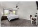 Spacious bedroom with a ceiling fan, two windows, and carpeted flooring at 41678 N Salix Dr, San Tan Valley, AZ 85140