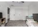 Bedroom featuring neutral walls, carpet, two doors, and a crib at 41678 N Salix Dr, San Tan Valley, AZ 85140