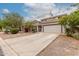 Charming two-story home with a desert-landscaped front yard, long driveway, and neutral color palette at 41678 N Salix Dr, San Tan Valley, AZ 85140