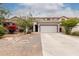 Charming two-story home with a desert-landscaped front yard, long driveway, and neutral color palette at 41678 N Salix Dr, San Tan Valley, AZ 85140