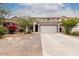 Inviting home with desert landscaping and a large driveway leading to a two-car garage at 41678 N Salix Dr, San Tan Valley, AZ 85140