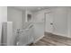 Upstairs hallway with wood flooring, white walls, a pet gate and two doors at 41678 N Salix Dr, San Tan Valley, AZ 85140